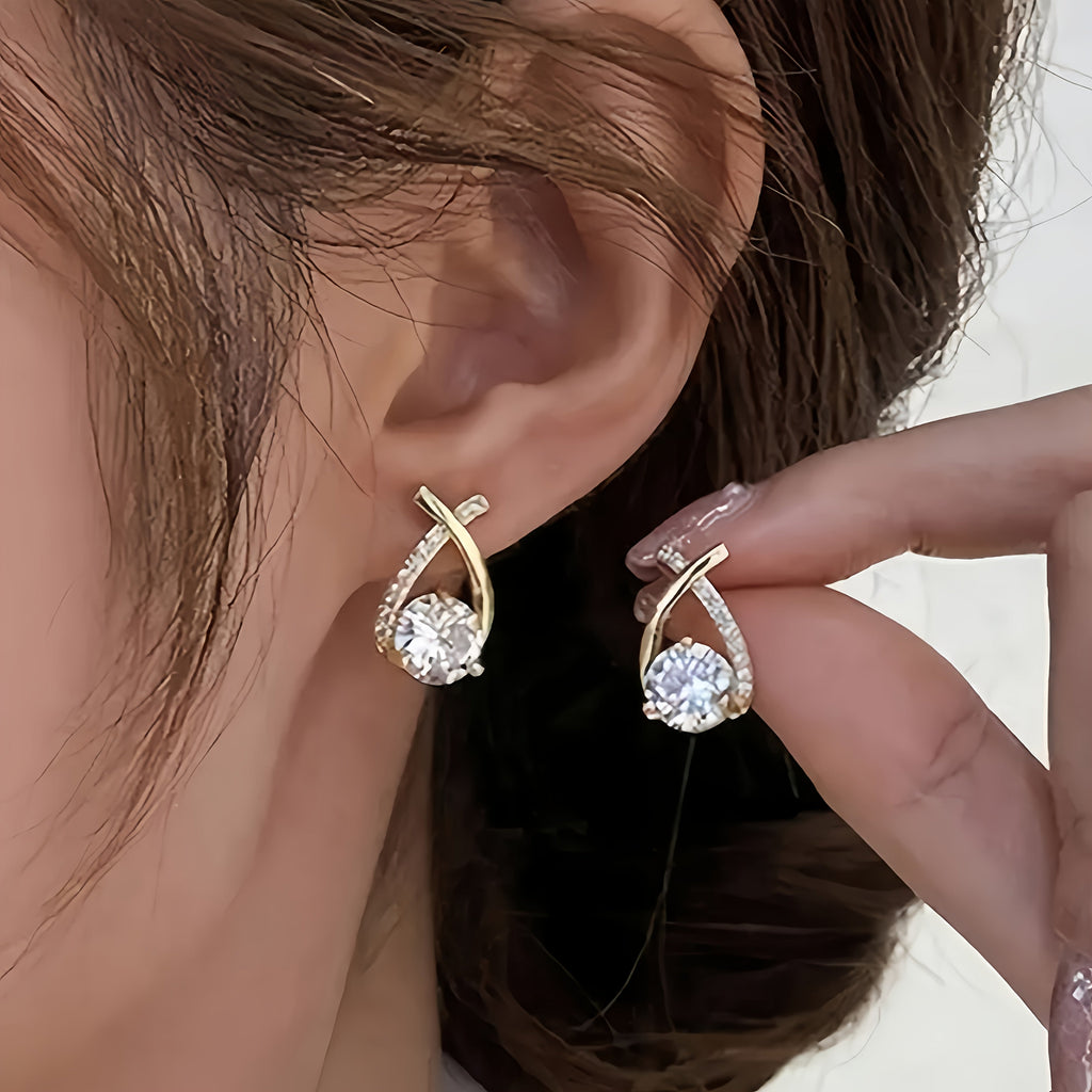 Sole – Orecchini con croce dorata e zircone