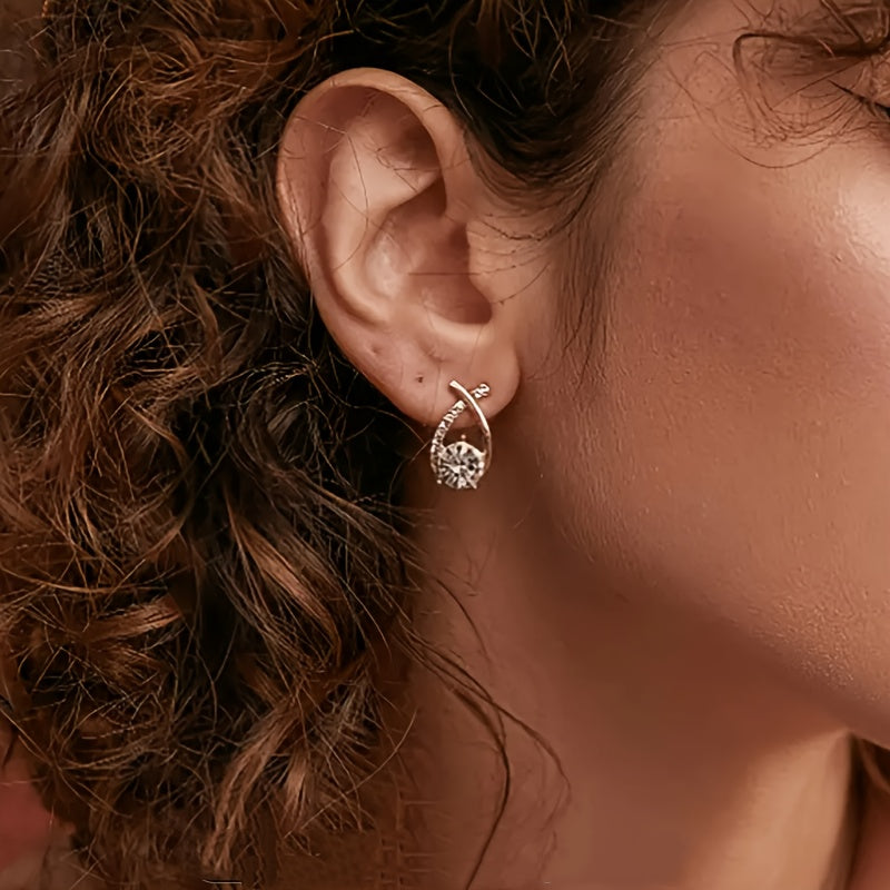 Sole – Orecchini con croce dorata e zircone
