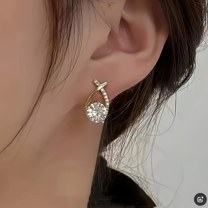 Sole – Orecchini con croce dorata e zircone