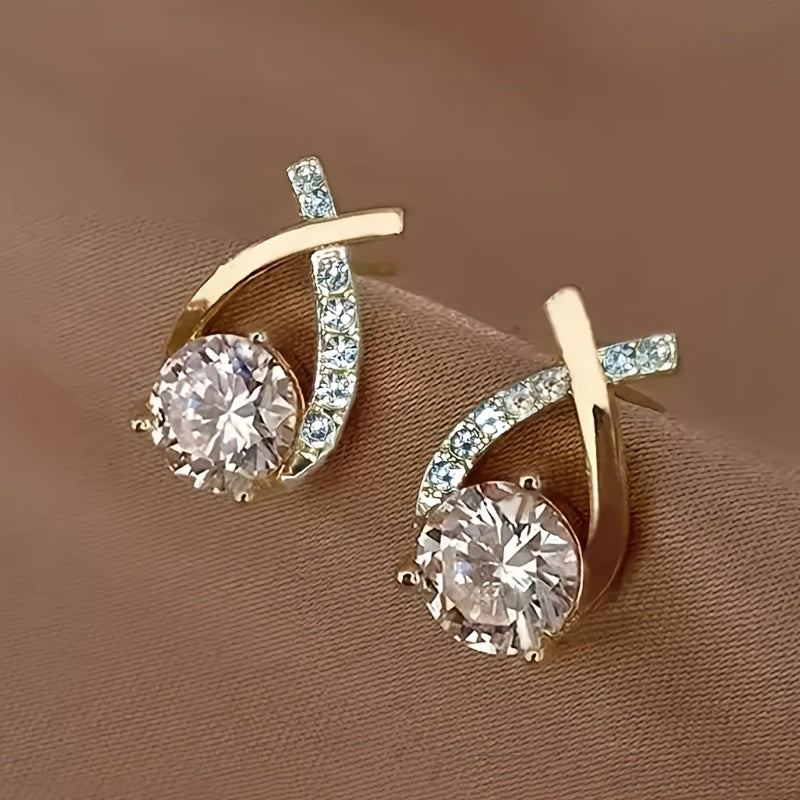 Sole – Orecchini con croce dorata e zircone